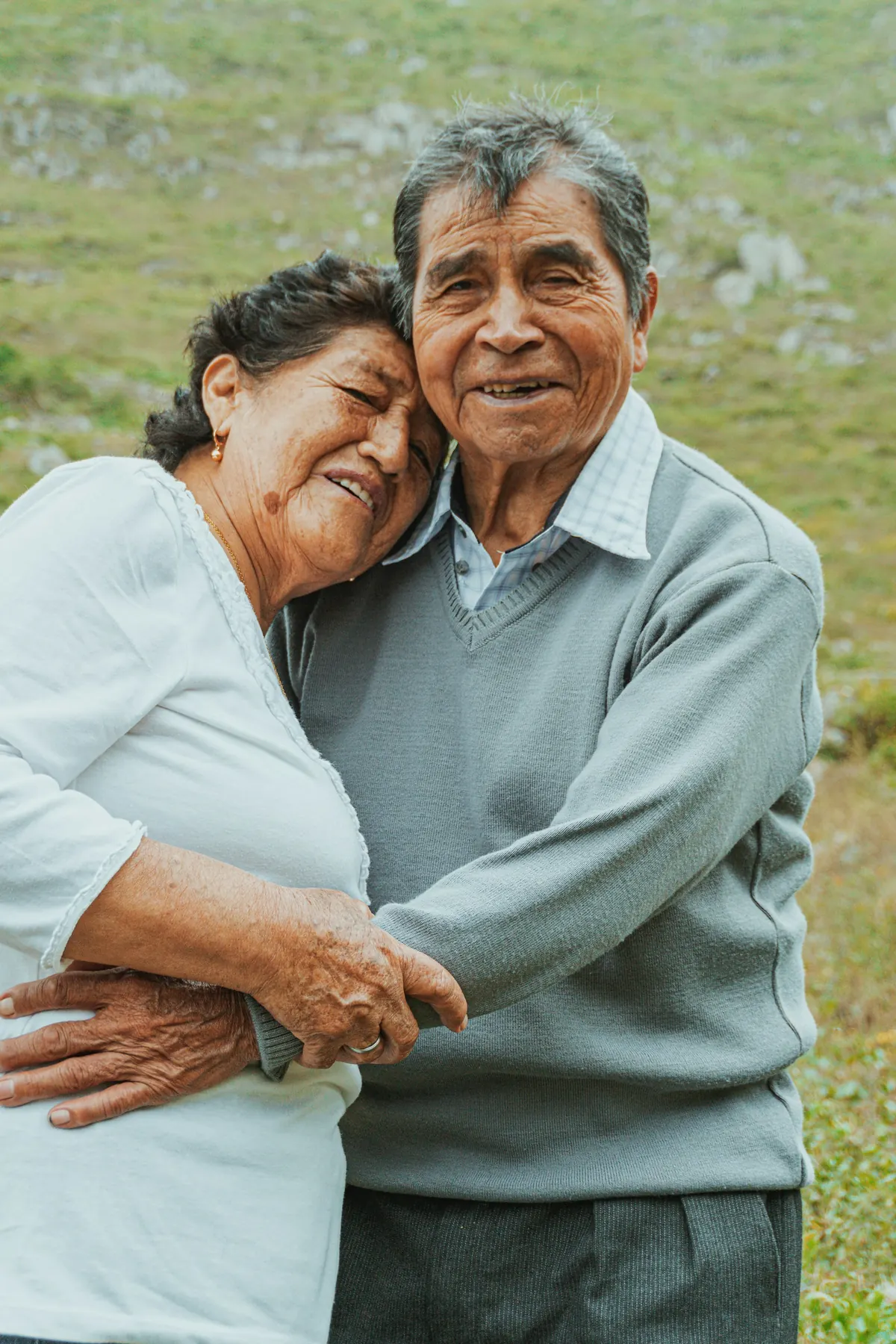A man and a woman hugging in a field